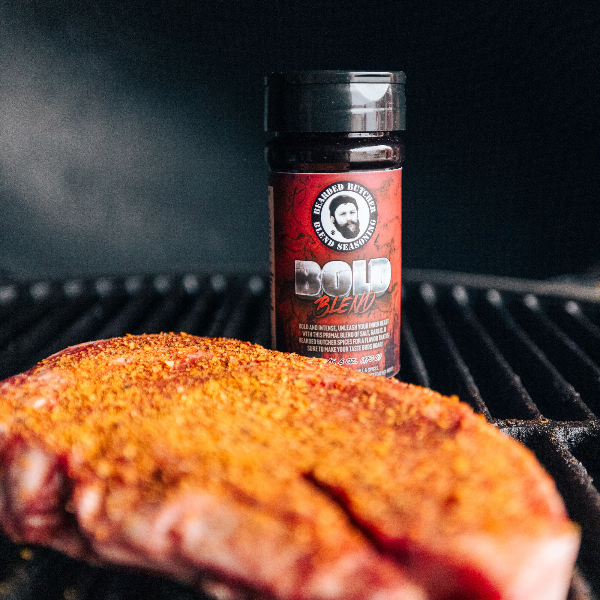 Steak on grill with Bearded Butcher Blend Bold Seasoning