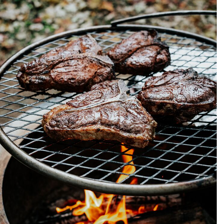 Bison and Elk Porterhouse steaks cooking