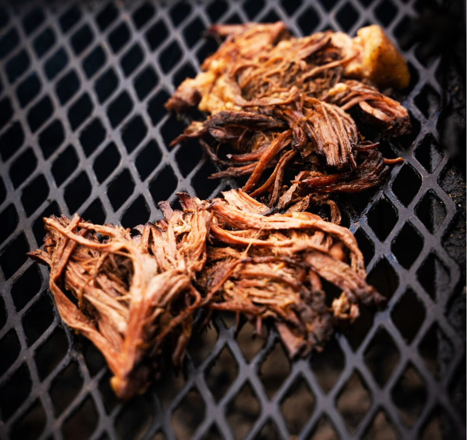 Shredded Smoked Brisket on a grill